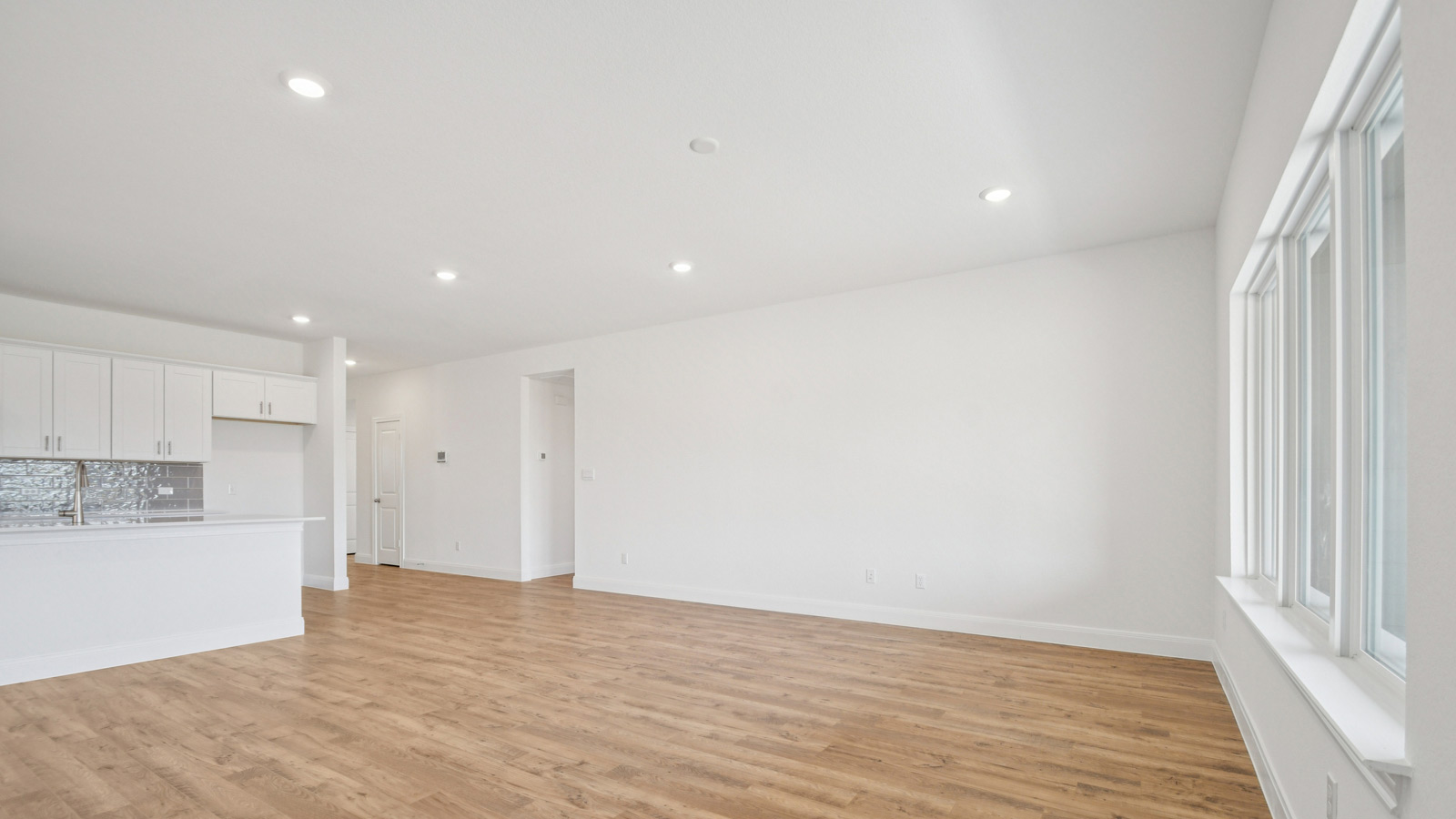 Spacious living area with windows and natural light.