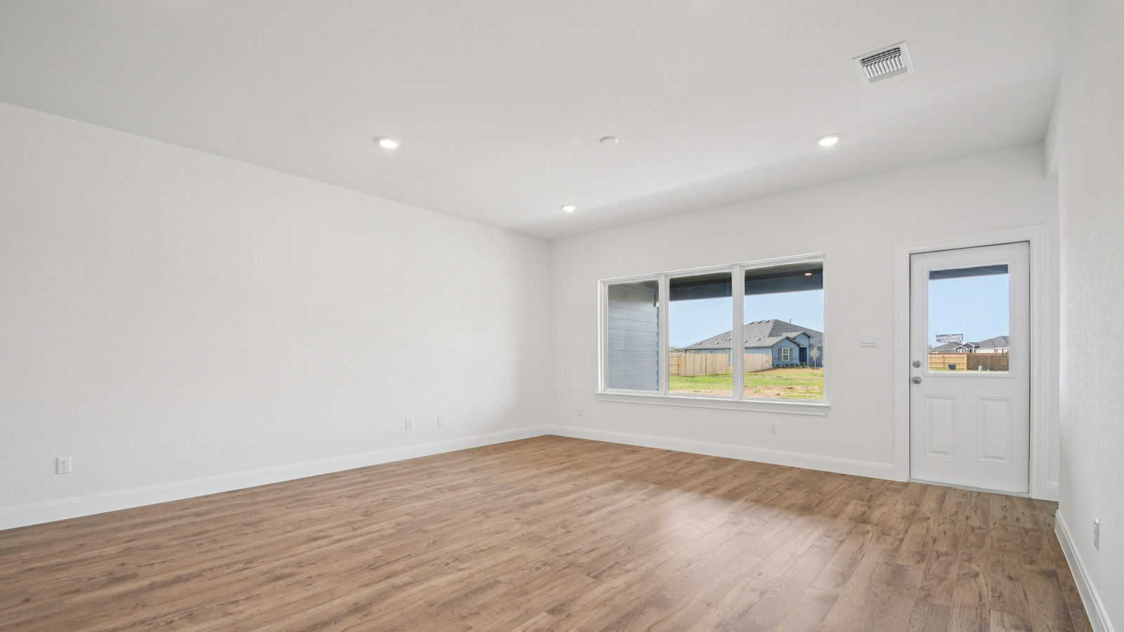 Spacious living area with windows and natural light.