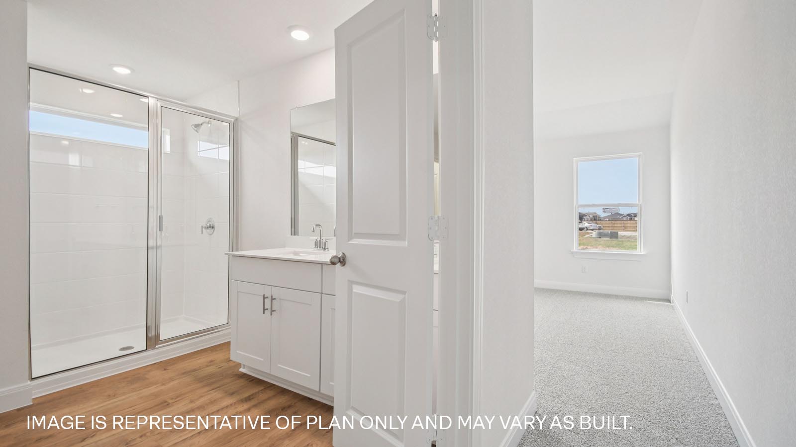 Primary bathroom with double doors and walk-in shower.