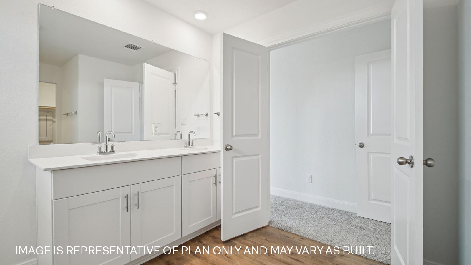 Primary bathroom with double doors and walk-in shower.