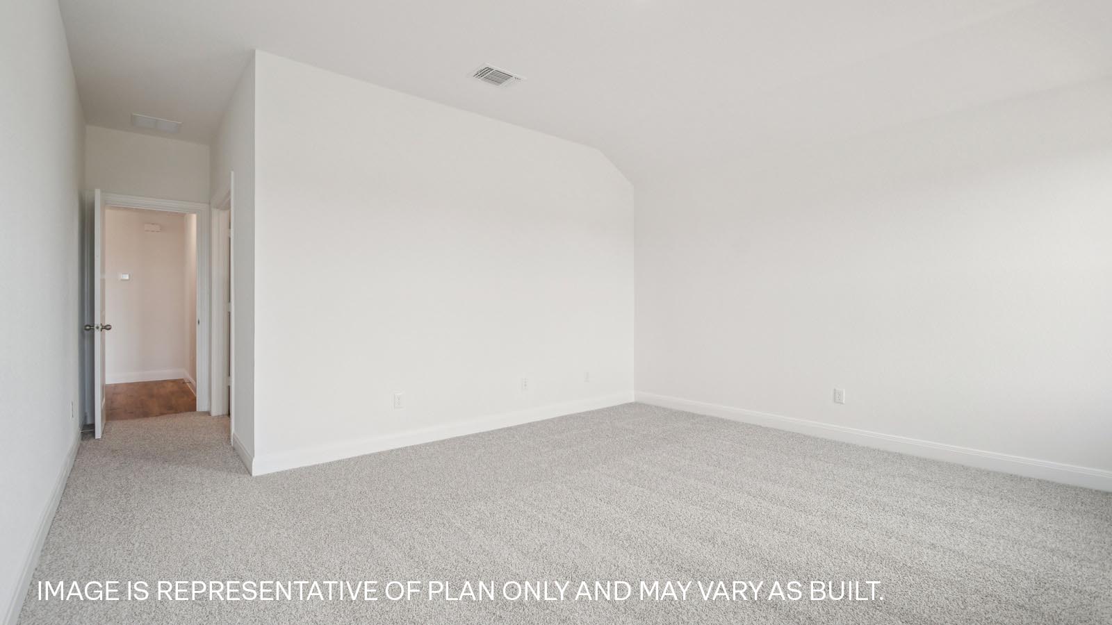 Spacious primary bedroom with two windows.