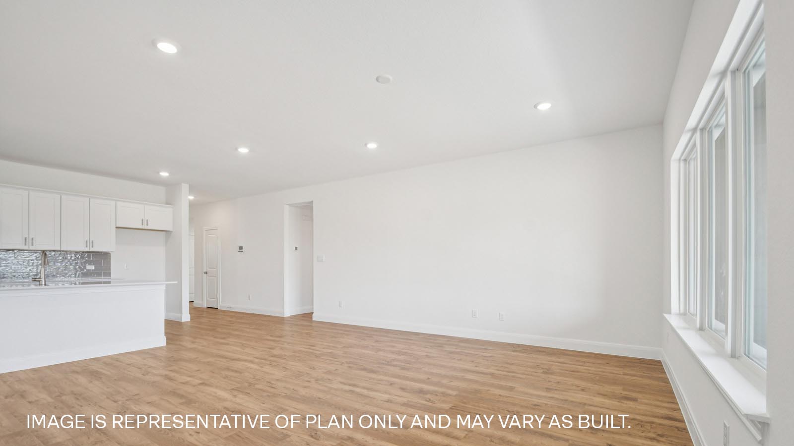Spacious living area with windows and natural light.