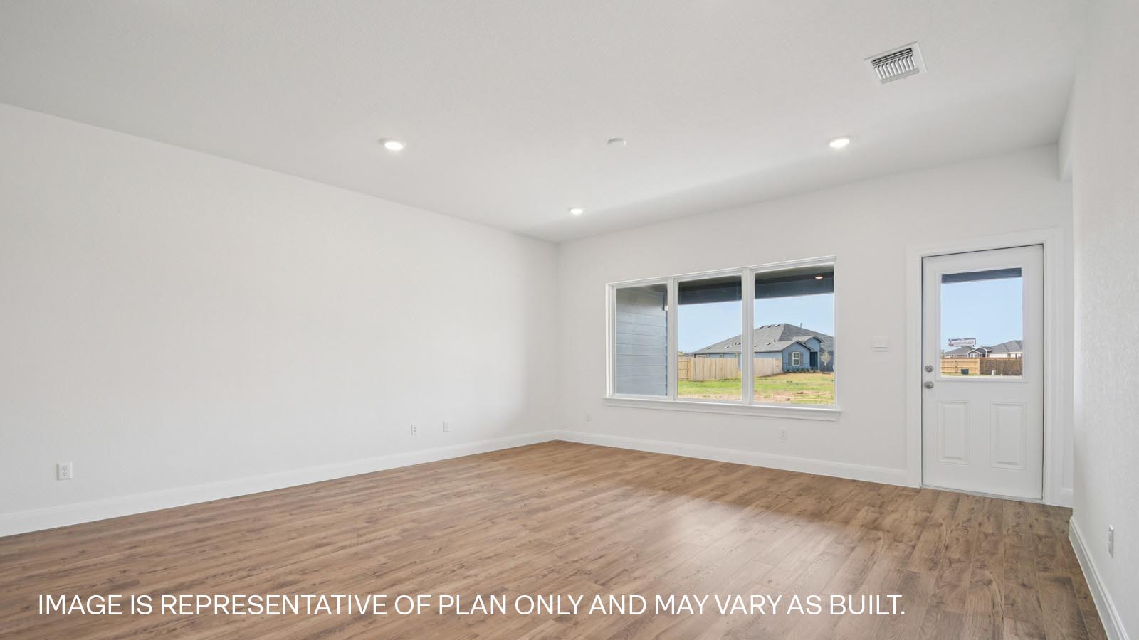 Spacious living area with windows and natural light.