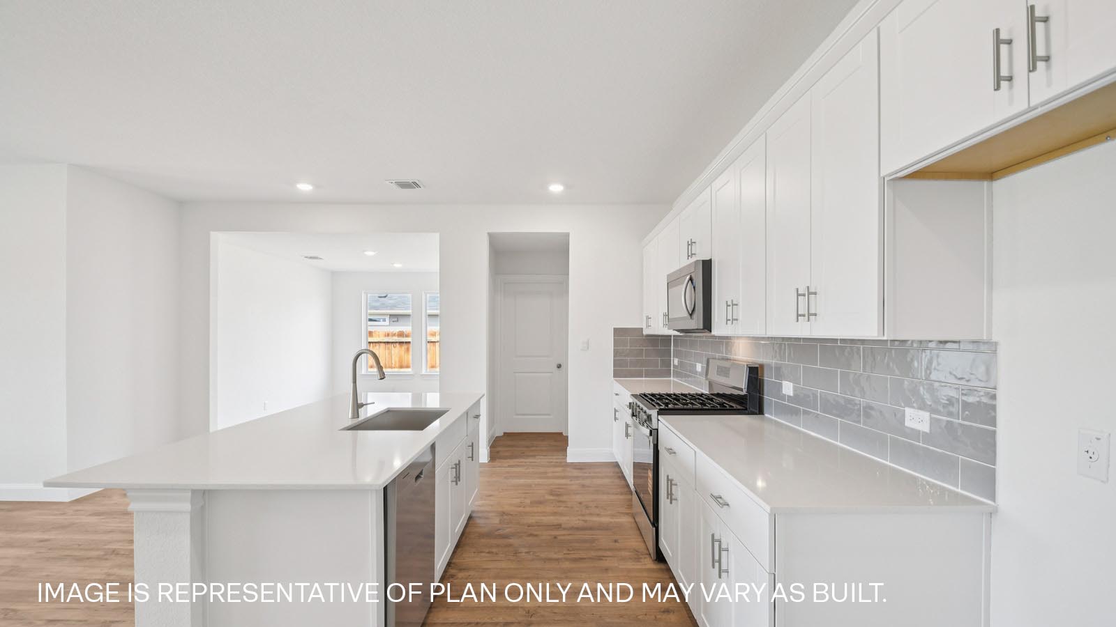 Gourmet kitchen with quartz countertops and decorative tile backsplash.