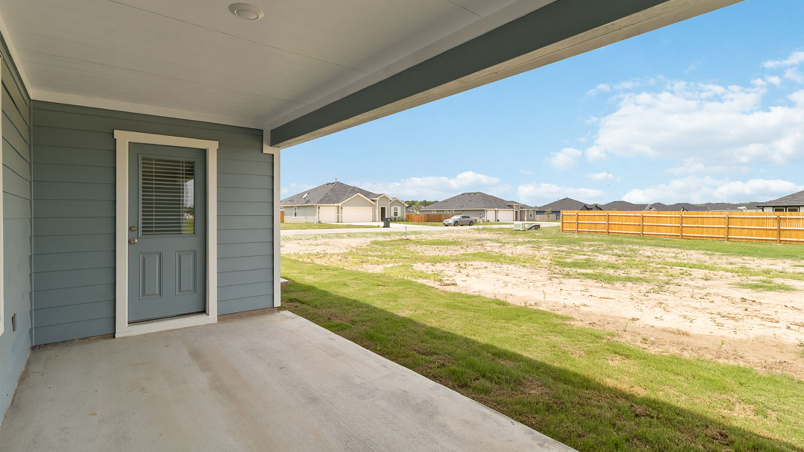 Covered back patio overlooking half acre lot.