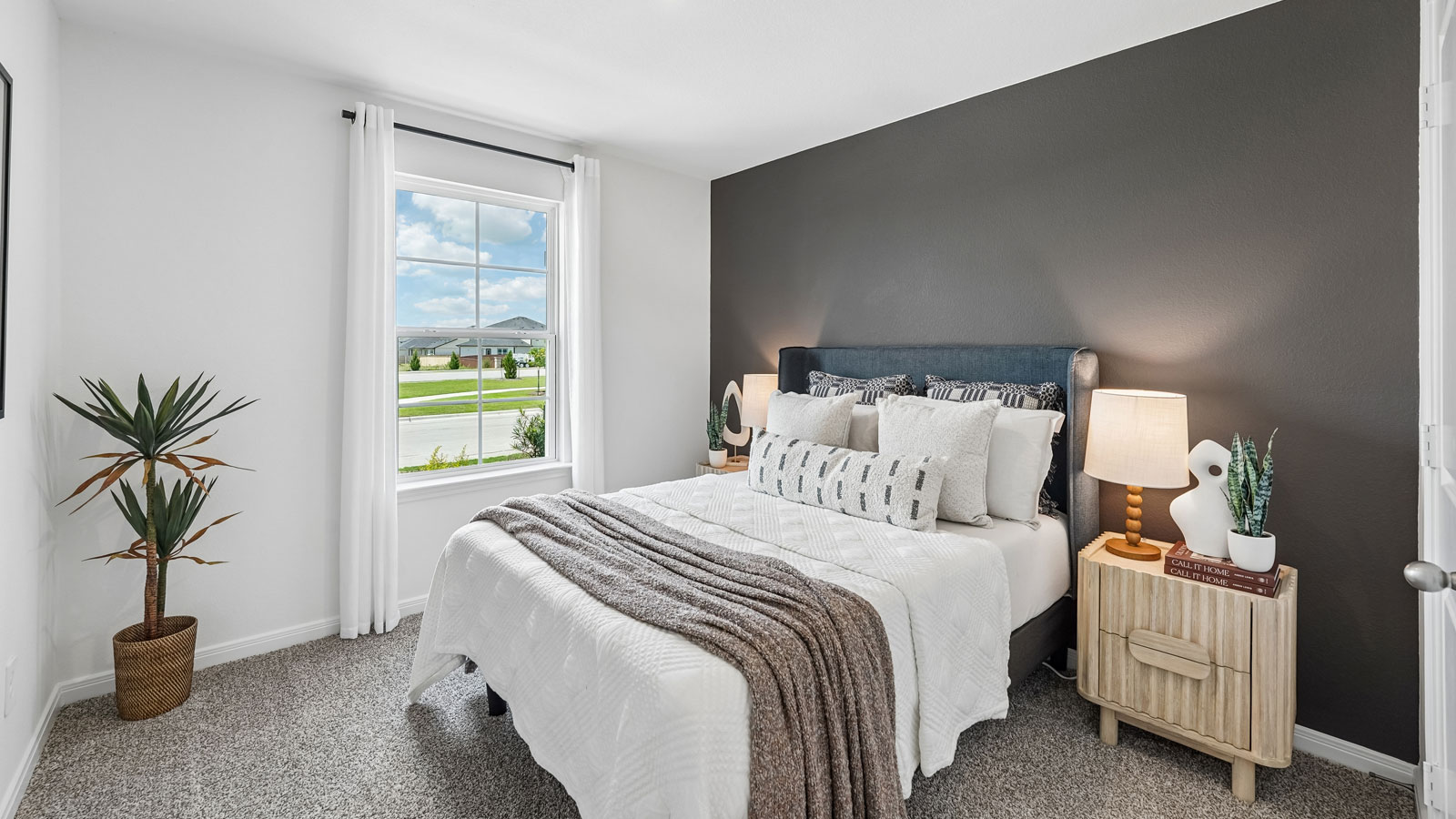 Secondary bedroom with carpeted flooring and window.