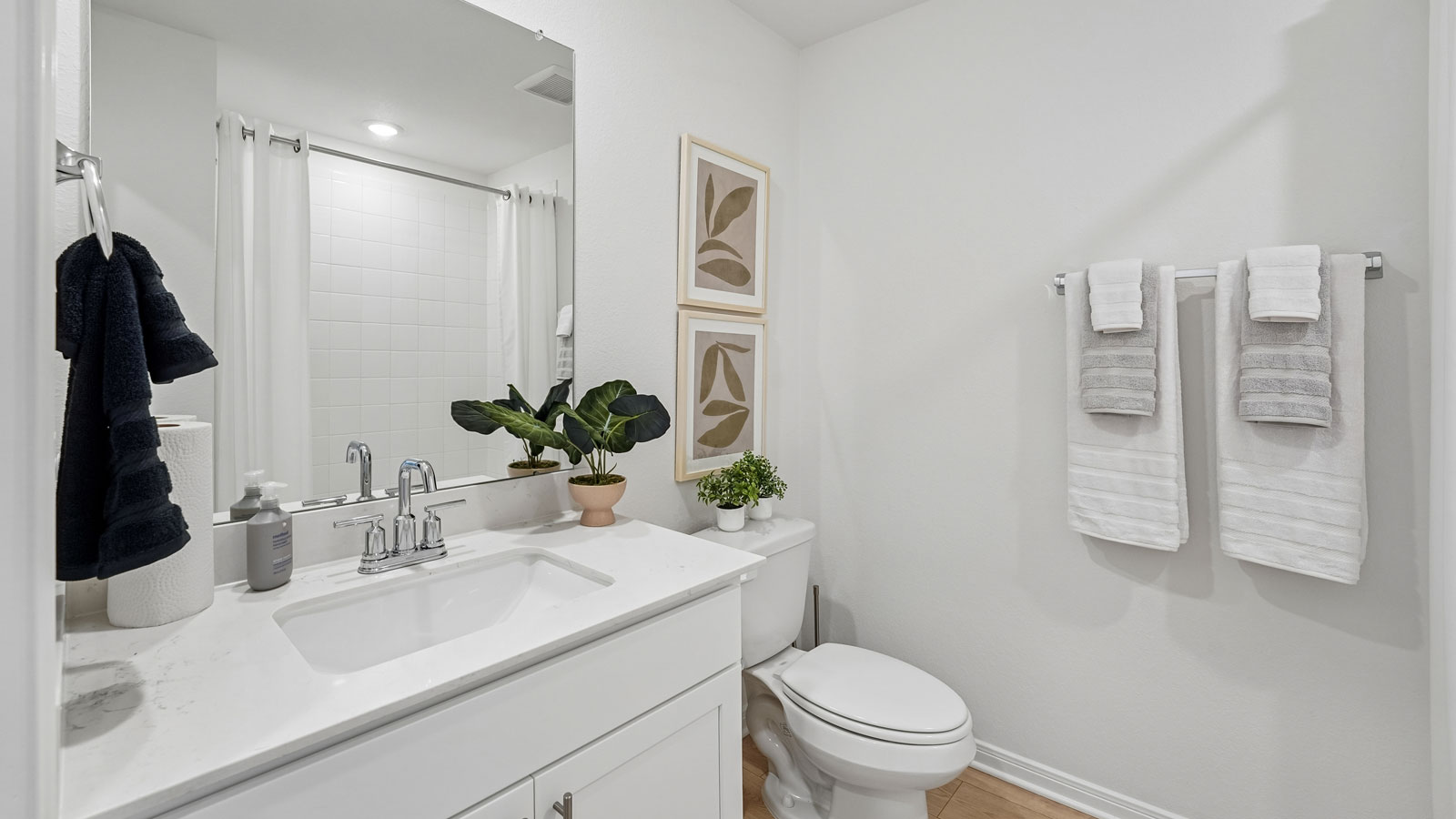 Secondary bathroom with tub and raised shower head.