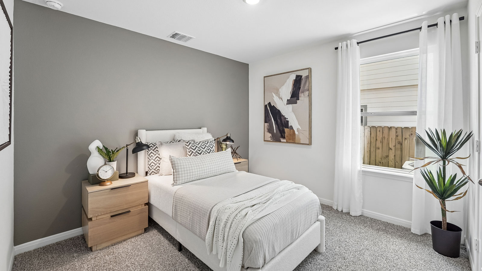 Bedroom 4 with carpeted flooring and window.