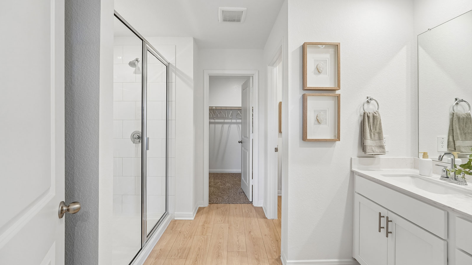 Primary bathroom with walk-in shower and double vanity sink.