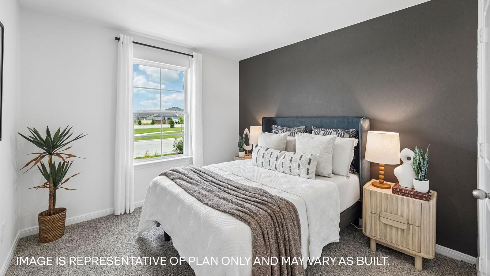 Secondary bedroom with carpeted flooring and window.
