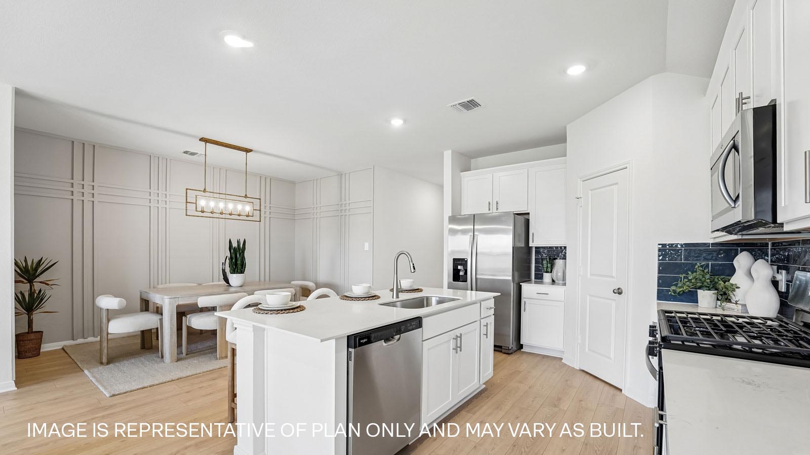 Kitchen island with sink and built-in dishwasher.