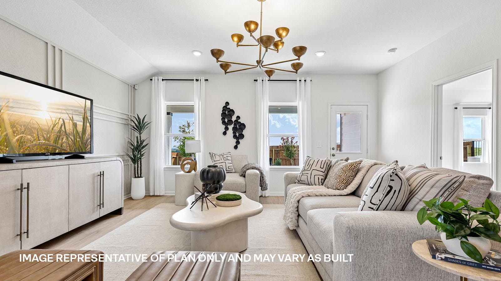 Open living area with premium laminate wood flooring at Kingston model home at Revelry in Del Valle, TX.