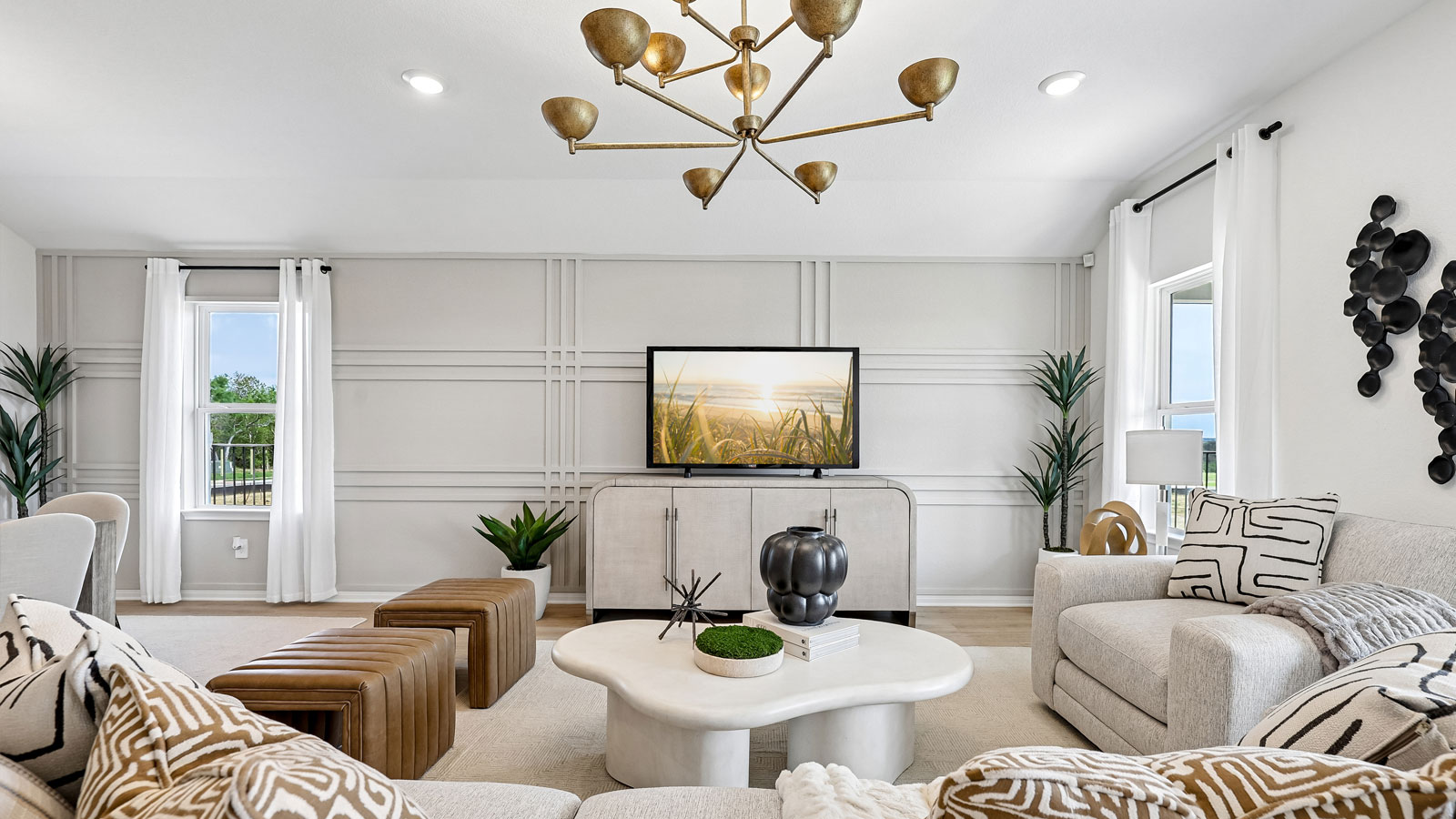 Open living area with premium laminate wood flooring at Kingston model home at Revelry in Del Valle, TX.