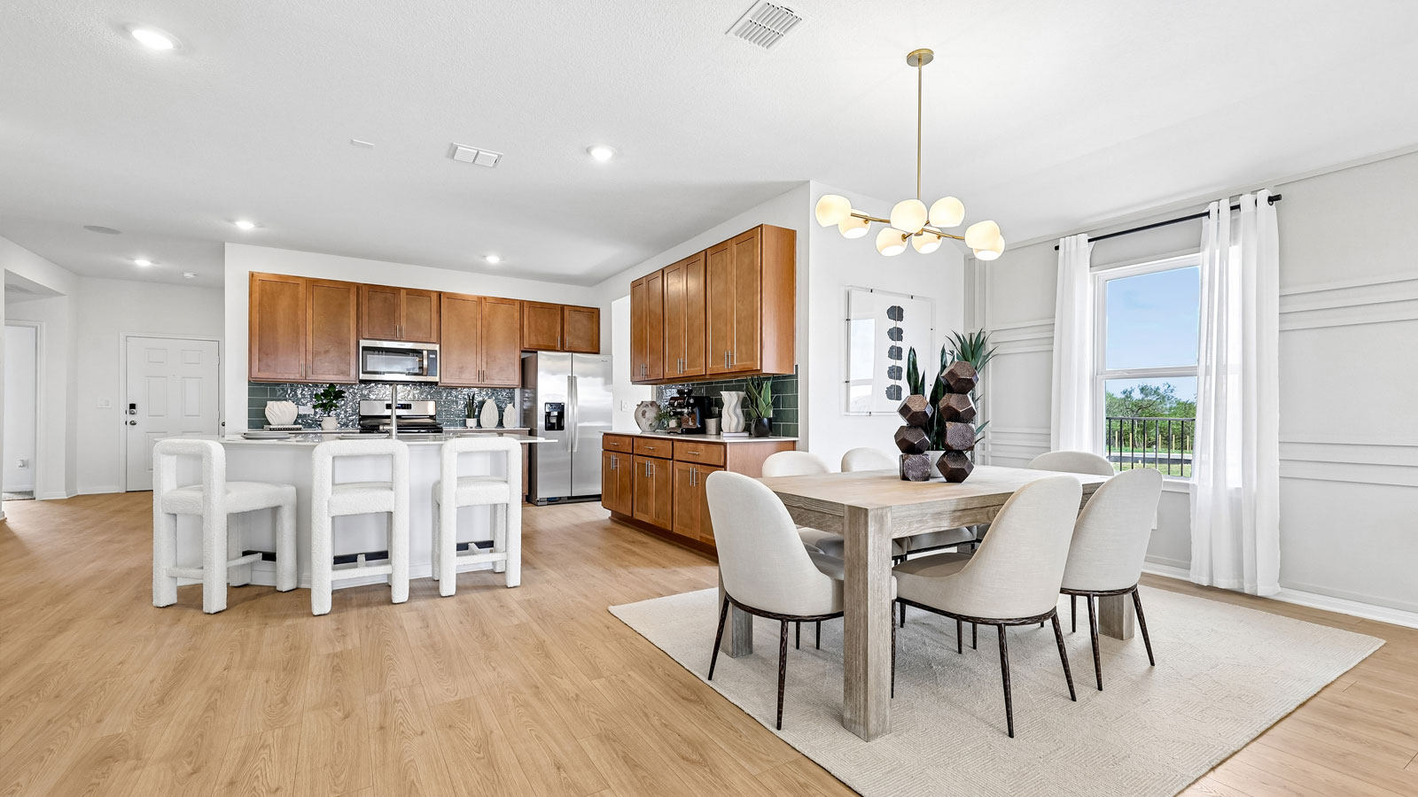 Dining area and kitchen inside model home.
