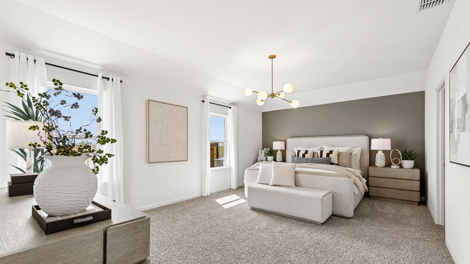 Spacious primary bedroom with carpeted flooring and ensuite bathroom.