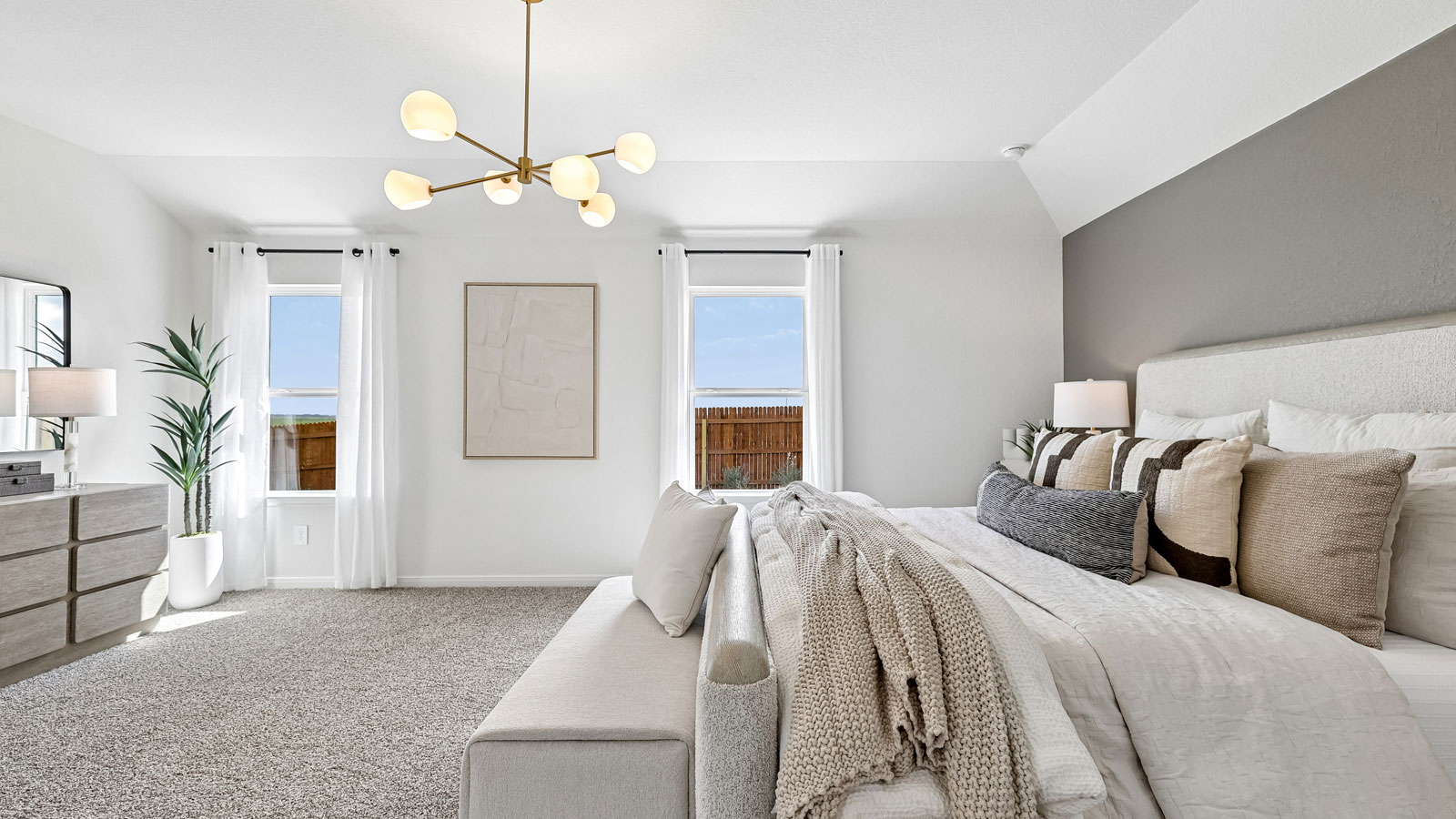 Spacious primary bedroom with carpeted flooring and ensuite bathroom.