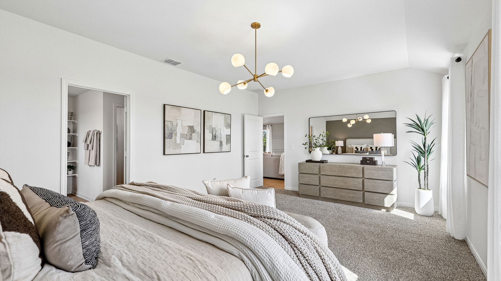 Spacious primary bedroom with carpeted flooring and ensuite bathroom.