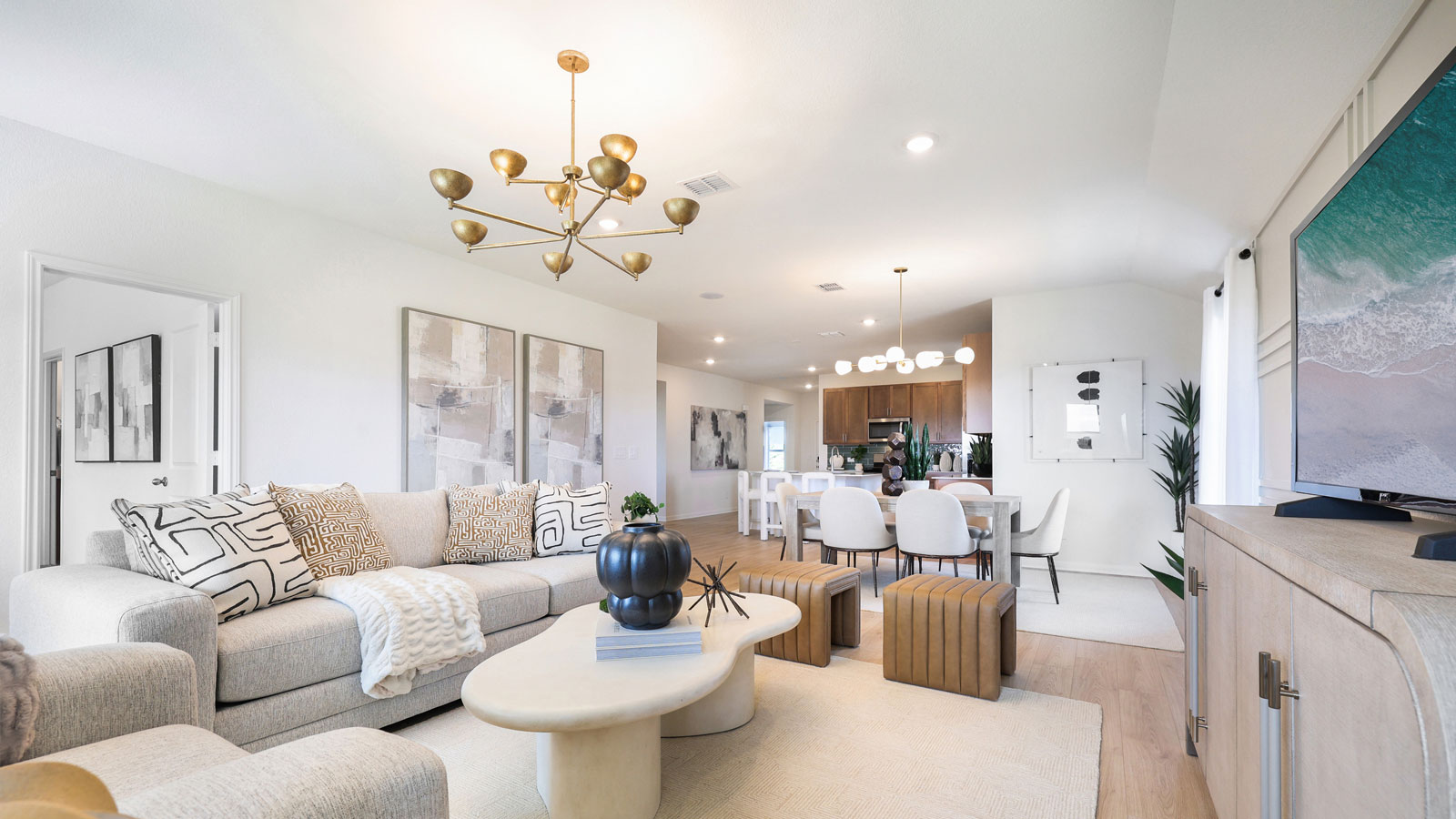 Open living area with premium laminate wood flooring at Kingston model home at Revelry in Del Valle, TX.