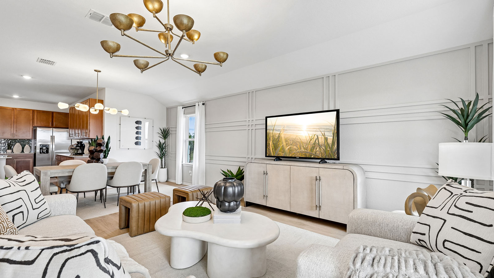 Open living area with premium laminate wood flooring at Kingston model home at Revelry in Del Valle, TX.