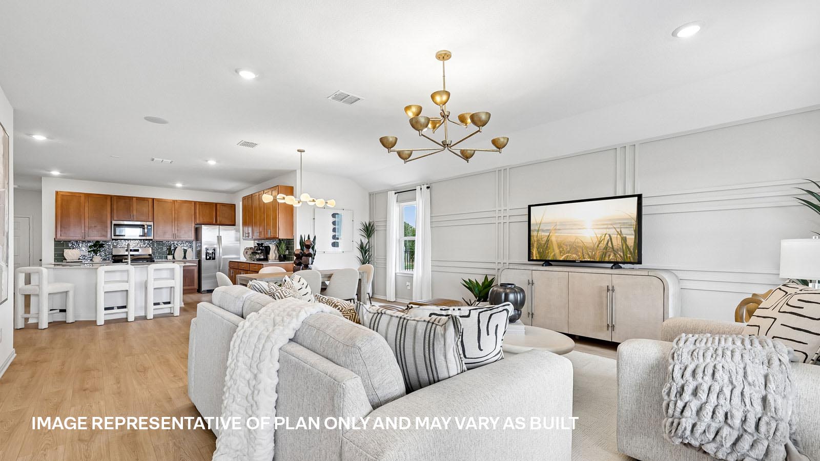 Open living area with premium laminate wood flooring at Kingston model home at Revelry in Del Valle, TX.