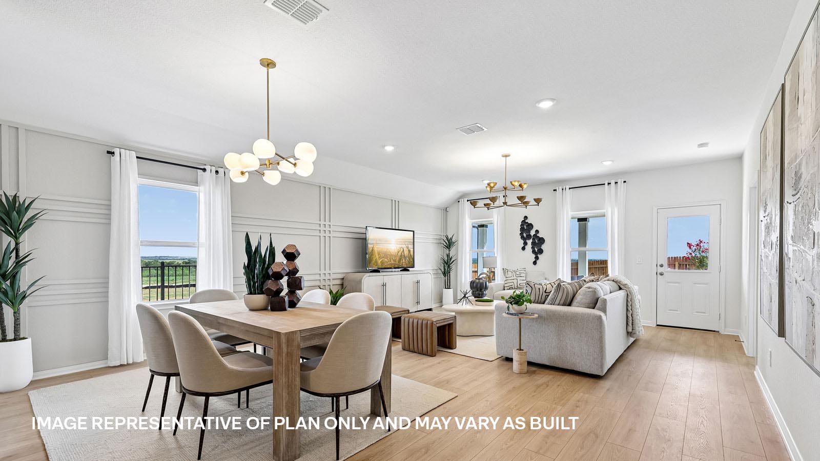 Open living area with premium laminate wood flooring at Kingston model home at Revelry in Del Valle, TX.