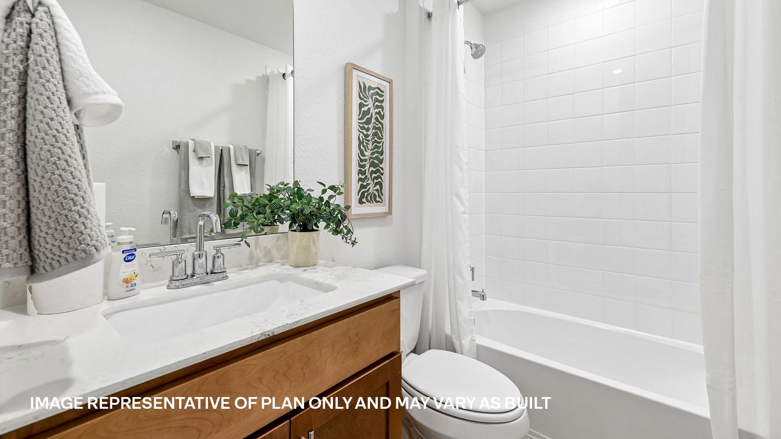 Secondary bathroom with raised shower head and bathtub.
