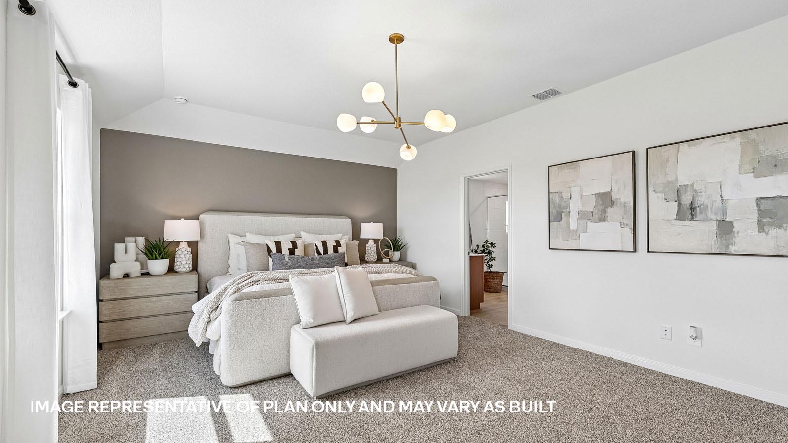 Spacious primary bedroom with carpeted flooring and ensuite bathroom.