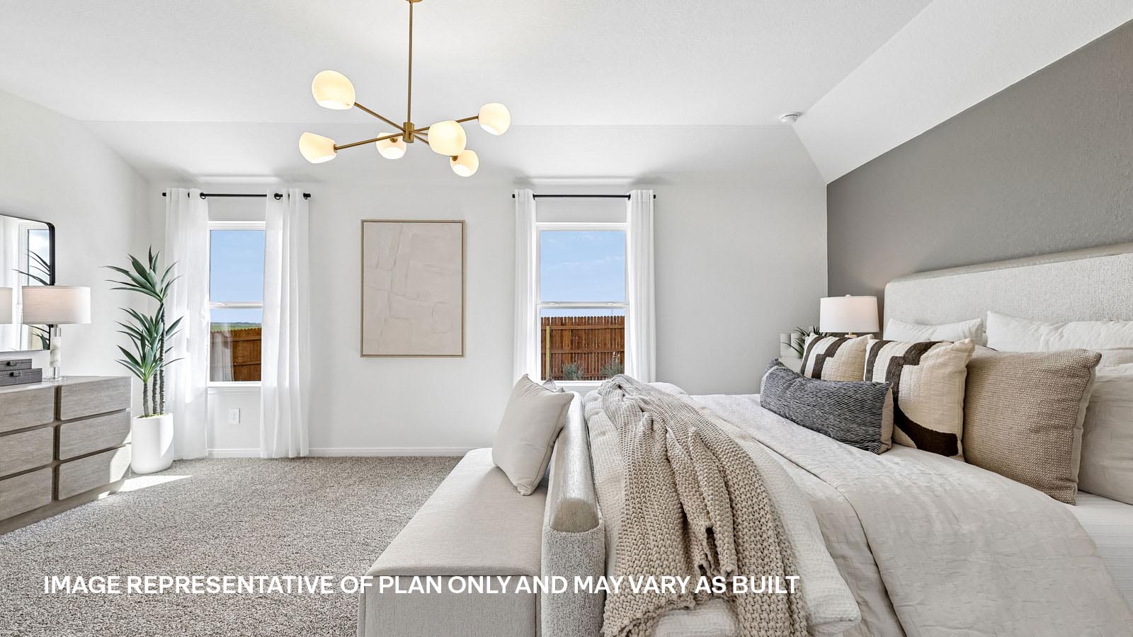 Spacious primary bedroom with carpeted flooring and ensuite bathroom.