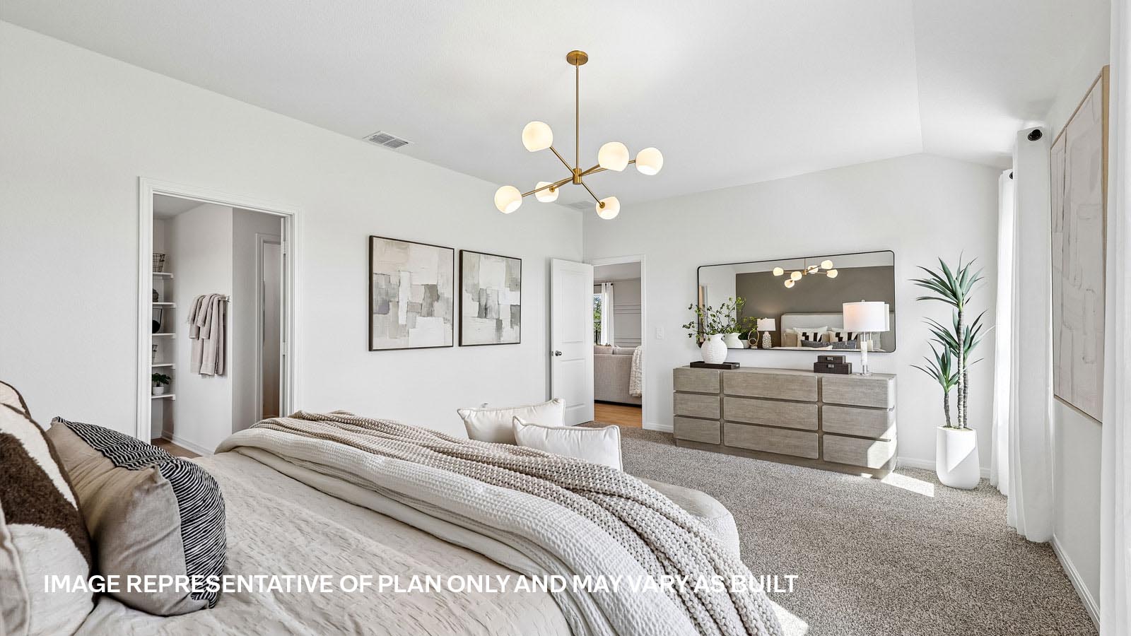 Spacious primary bedroom with carpeted flooring and ensuite bathroom.