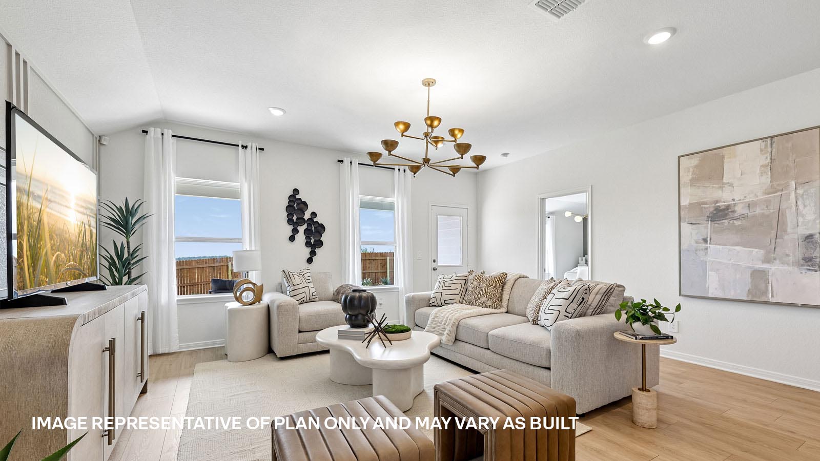 Open living area with premium laminate wood flooring at Kingston model home at Revelry in Del Valle, TX.