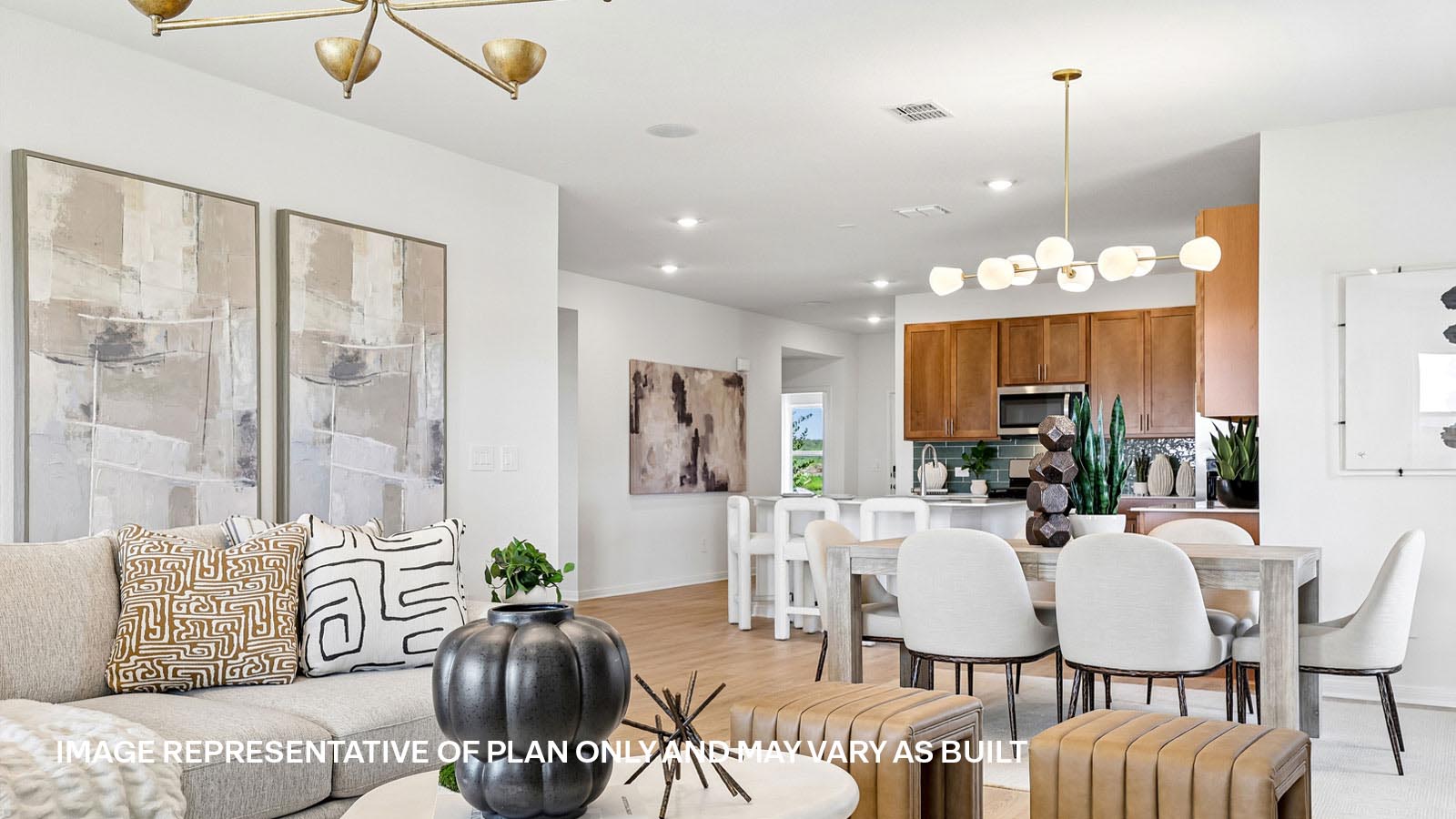 Open living area with premium laminate wood flooring at Kingston model home at Revelry in Del Valle, TX.
