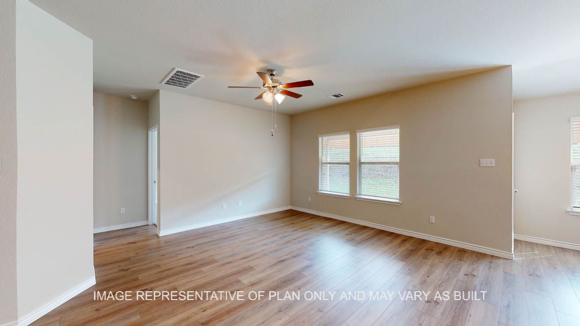 Auburn living room with vinly plank flooring and windows for natural lighting.