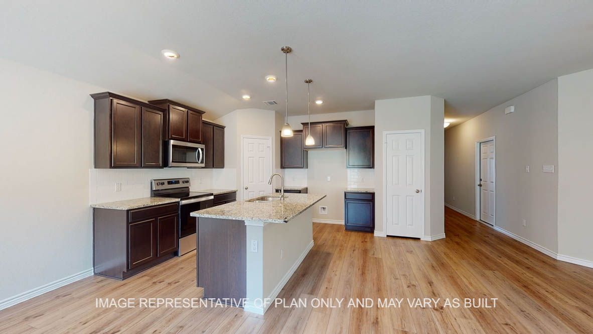 Auburn kitchen with vinyl plank flooring thoughout the open concept living area.