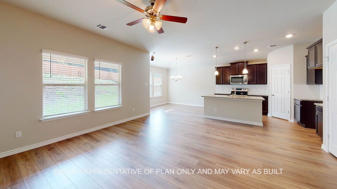 Auburn living room with vinly plank flooring and windows for natural lighting.
