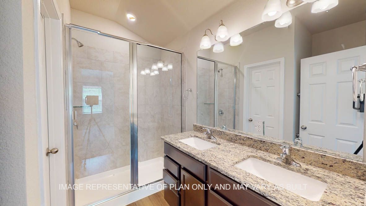 Auburn primary bathroom with walk-in shower and granite countertops.