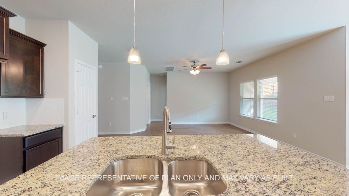 Auburn kitchen with granite island and undermount stainless sink.
