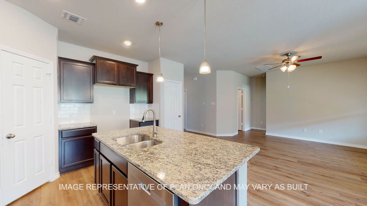 Auburn kitchen with granite countertops and vinyl plank flooring.