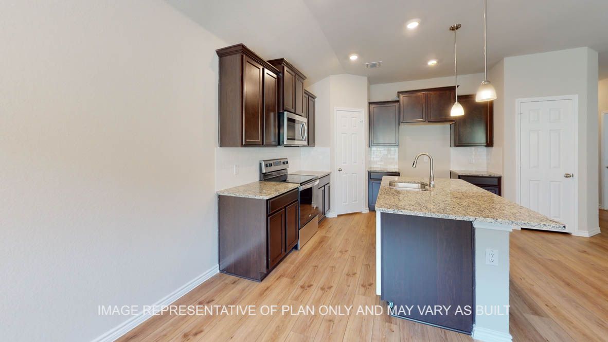 Auburn dining room with view into open concept kitchen.