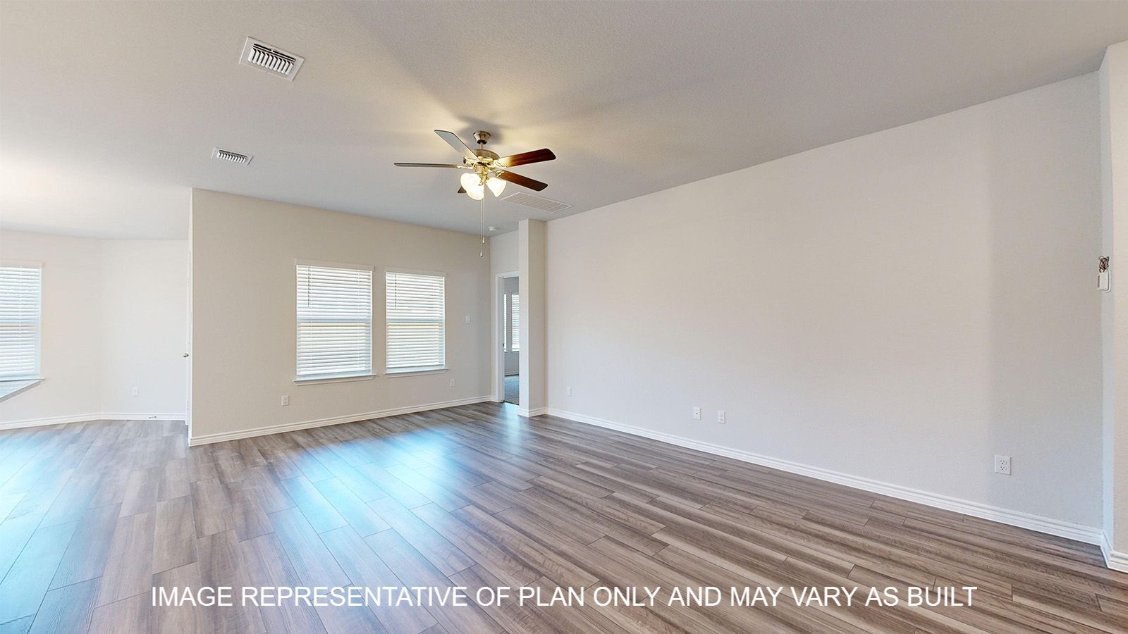 Alpine living room with vinyl plank flooring and windows offering natural lighting.