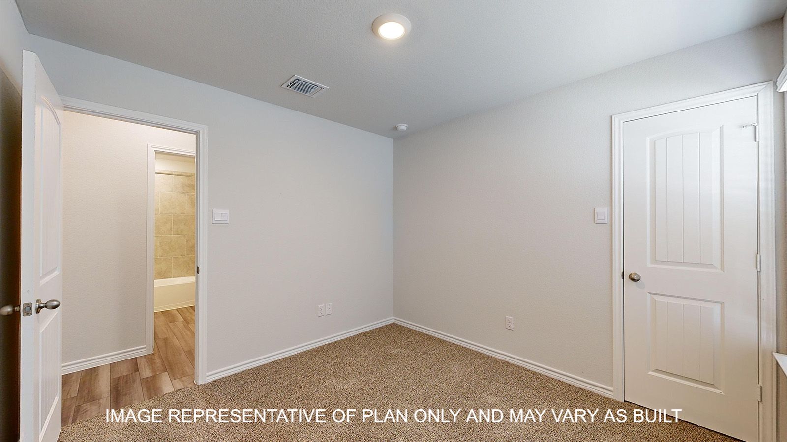 Alpine secondary bedroom with carpet flooring and closet door.