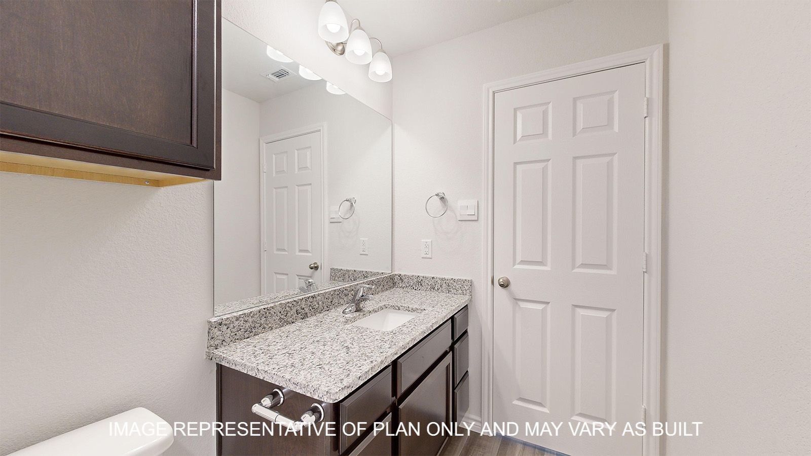 Dakota secondary bathroom with granite countertops and dark cabinets.