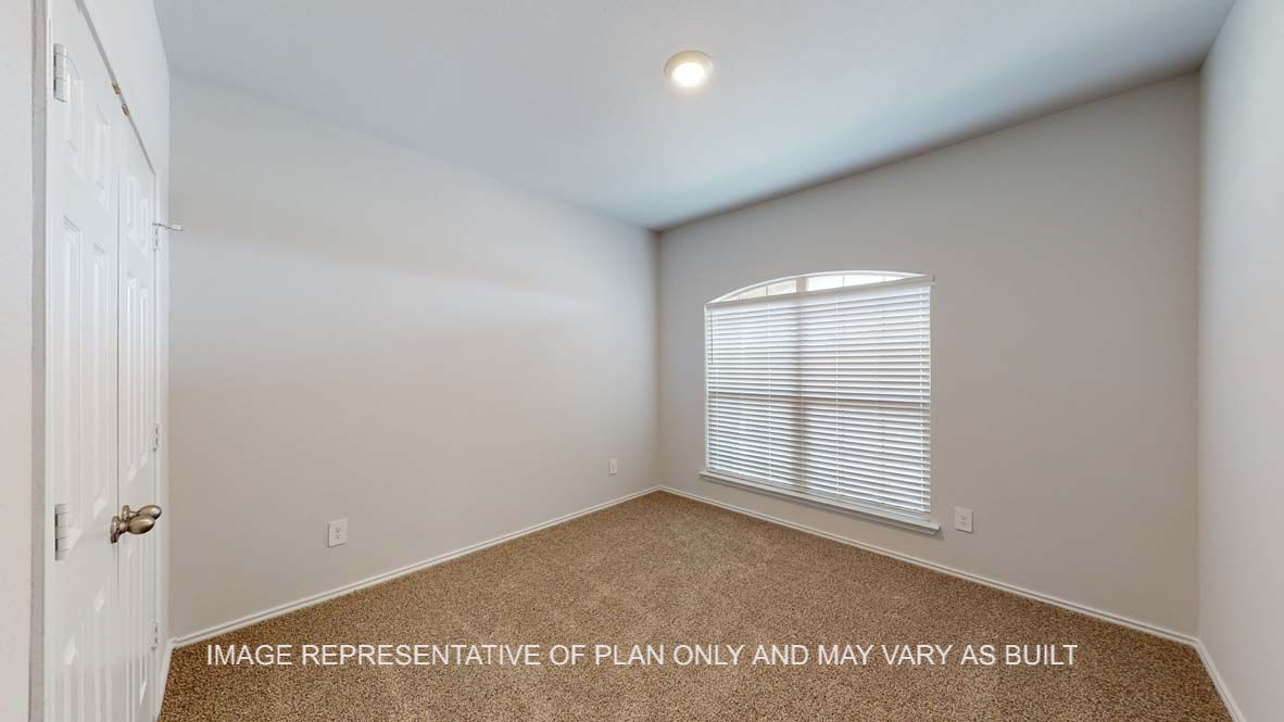 Roosevelt secondary bedroom with carpet flooring and window.