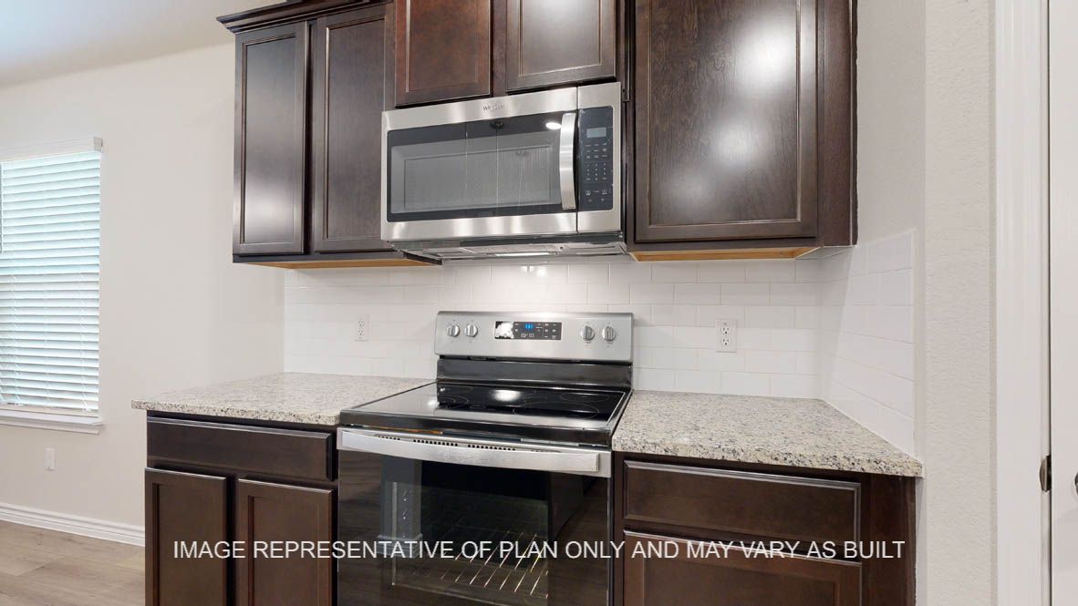 Richmond kitchen with dark cabinets and stainless appliances.
