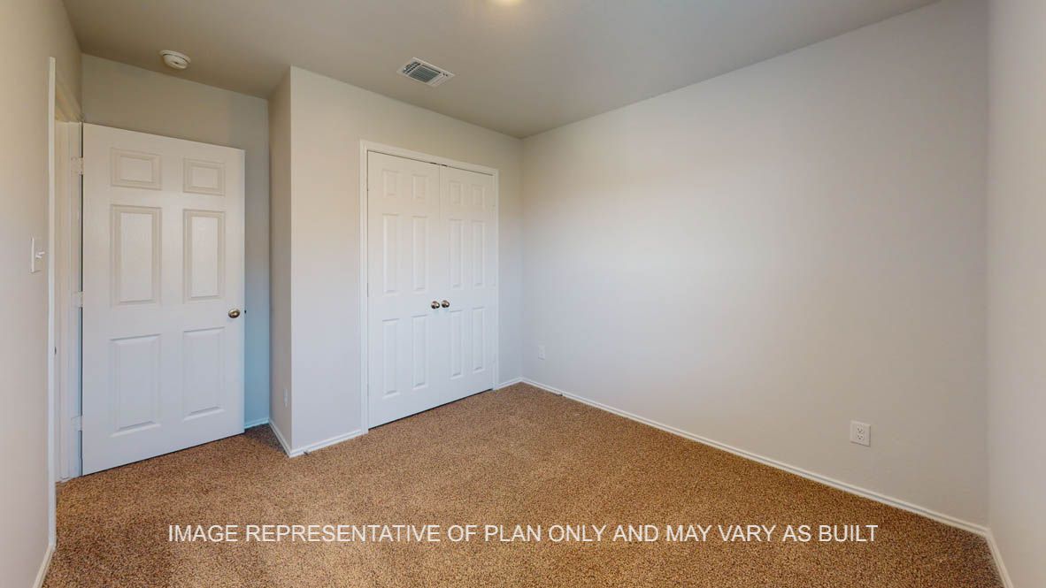 Prescott secondary bedroom with view to closet doors and carpet flooring.