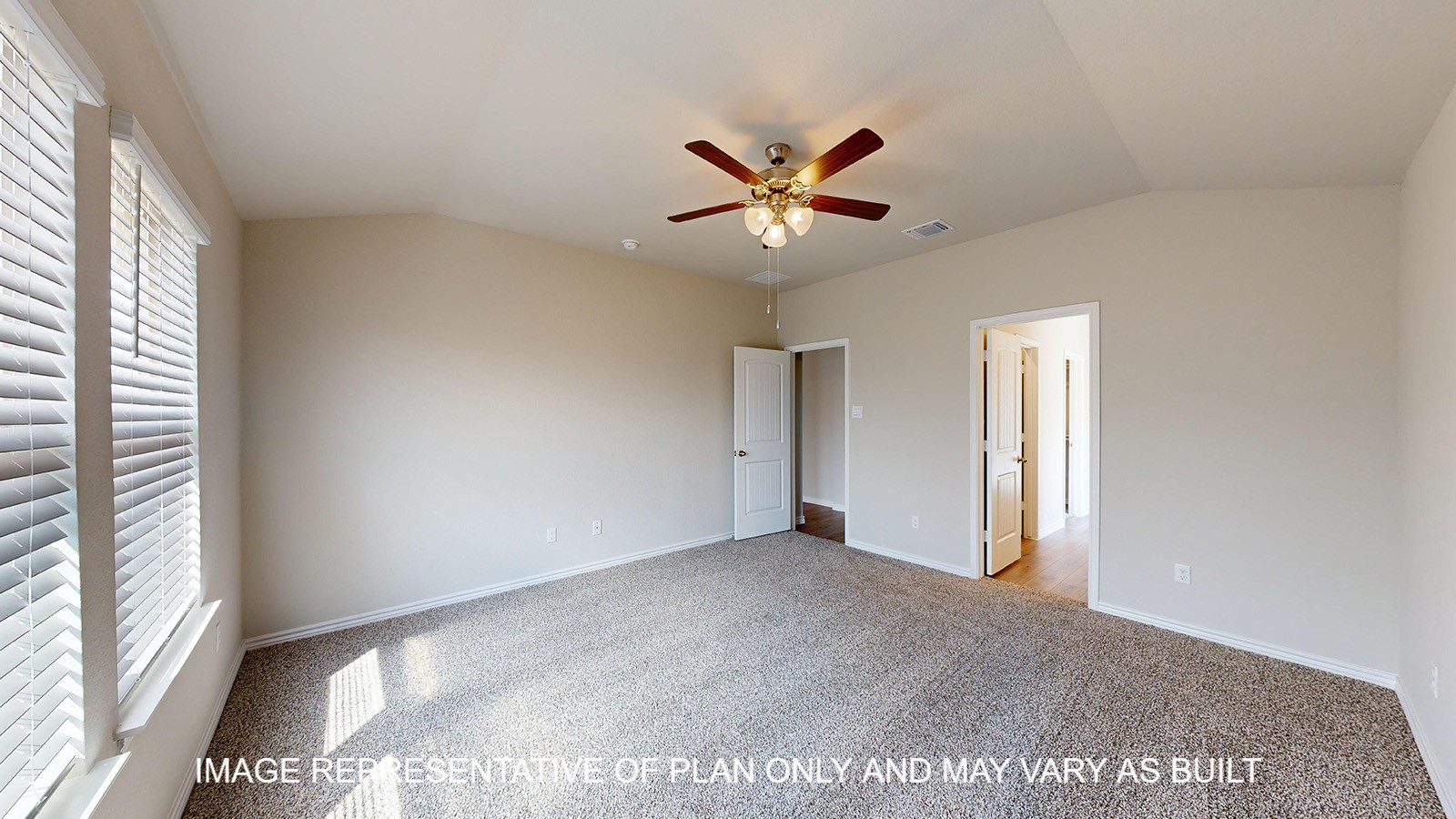 Monroe primary bedroom with carpet flooring and ceiling fan.