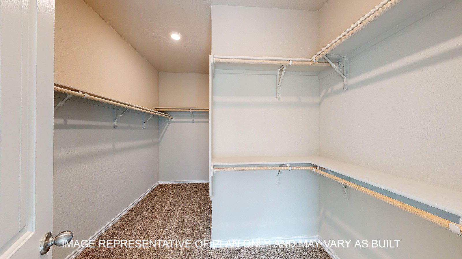 Monroe primary bedroom closet with carpet flooring and plenty of shelving space for storage.