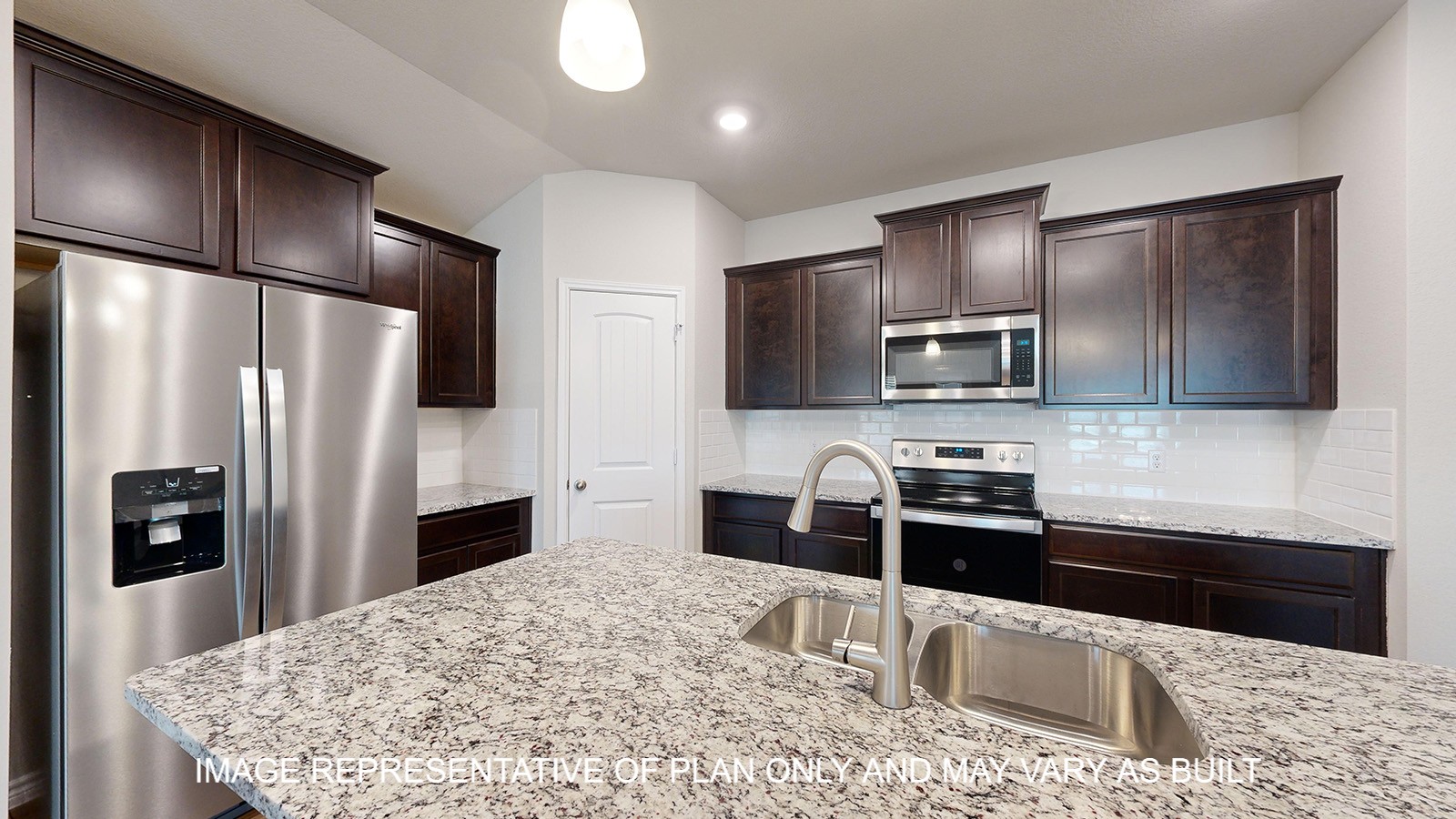 Monroe kitchen with granite countertops and dark cabinets.