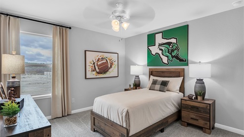 Creekfall model home secondary bedroom with twin size bed and accent decor.