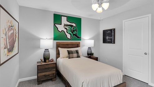 Creekfall model home secondary bedroom with twin size bed and closet door.
