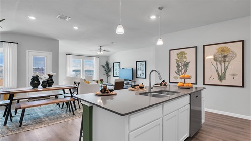 Creekfall model home kitchen with granite counter and island.
